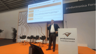 Anthony Ambrose, CEO of Data I/O speaks during a forum presentation at Productronica 2023